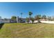 This large, grassy backyard offers a pool, privacy fence, and beautiful landscaping at 17 Se 61St Ct, Ocala, FL 34472