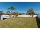 Backyard featuring a grassy lawn, tropical landscaping, and a privacy fence at 17 Se 61St Ct, Ocala, FL 34472