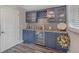 Bar area with blue cabinets, granite countertops, and mini fridge at 17 Se 61St Ct, Ocala, FL 34472