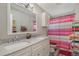 Bathroom offers a double vanity and shower with a patterned curtain at 17 Se 61St Ct, Ocala, FL 34472