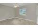 Empty bedroom featuring gray walls, carpet flooring and a window with blinds at 17 Se 61St Ct, Ocala, FL 34472