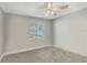 Empty bedroom featuring gray walls, carpet flooring and a window with blinds at 17 Se 61St Ct, Ocala, FL 34472