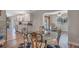 Bright dining area with a glass table, wood floors, and a view of the kitchen and living room at 17 Se 61St Ct, Ocala, FL 34472