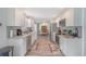 Bright kitchen with white cabinetry, stainless appliances, and views into the dining area at 17 Se 61St Ct, Ocala, FL 34472