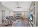 Inviting living room features a large sectional sofa, wood flooring, and custom shelving with a flatscreen TV at 17 Se 61St Ct, Ocala, FL 34472