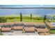 Aerial view showcasing the townhomes with lake view, garages, and a community pool at 2500 21St Nw St # 88, Winter Haven, FL 33881