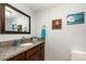 Charming bathroom features granite countertop, a decorative mirror, and a toilet at 2500 21St Nw St # 88, Winter Haven, FL 33881