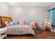 This room is cute and cozy, with a charming bed frame, patterned bedding, and colorful decor at 2500 21St Nw St # 88, Winter Haven, FL 33881