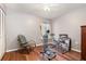 Neutral tones create a peaceful bedroom featuring hardwood floors, a rocking chair, and exercise equipment at 2500 21St Nw St # 88, Winter Haven, FL 33881