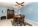 Light-filled dining room with skylights, blue walls, and a classic wooden table at 2500 21St Nw St # 88, Winter Haven, FL 33881