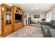Cozy living room with hardwood floors, ceiling fan, and large entertainment center at 2500 21St Nw St # 88, Winter Haven, FL 33881