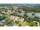 Beautiful aerial view of a lakeside community surrounded by lush green trees and well-maintained homes at 2569 Rogers Rd, Lakeland, FL 33812