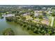 Picturesque aerial shot of community homes along a lake, blending nature and neighborhood at 2569 Rogers Rd, Lakeland, FL 33812