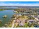 Aerial view of home foundation on a waterfront lot surrounded by trees and other homes at 2569 Rogers Rd, Lakeland, FL 33812