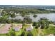 Aerial view of homes, including a lake view, in a serene community at 2569 Rogers Rd, Lakeland, FL 33812