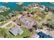 An aerial view of property showcasing the foundation, surrounding trees, and a nearby lake at 2569 Rogers Rd, Lakeland, FL 33812