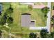 Overhead view displaying the home's layout, with a well-kept lawn and surrounding greenery at 2569 Rogers Rd, Lakeland, FL 33812