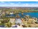 Aerial view of a real estate lot with lake and neighborhoods in the distance under a sunny sky at 2569 Rogers Rd, Lakeland, FL 33812