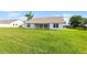 Back of the home with doors leading to a large yard, perfect for outdoor activities at 2569 Rogers Rd, Lakeland, FL 33812