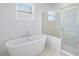 Modern bathroom showcasing a freestanding tub and glass-enclosed shower at 2569 Rogers Rd, Lakeland, FL 33812