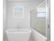 Modern bathroom showcasing a freestanding tub and glass-enclosed shower at 2569 Rogers Rd, Lakeland, FL 33812