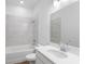 Elegant bathroom featuring marble-look tiled shower and a modern vanity with sleek fixtures at 2569 Rogers Rd, Lakeland, FL 33812