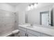 Stylish bathroom featuring marble-look tiled shower, sleek vanity, and modern fixtures at 2569 Rogers Rd, Lakeland, FL 33812