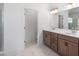 Elegant bathroom featuring a double vanity, quartz countertops, and ample lighting at 2569 Rogers Rd, Lakeland, FL 33812