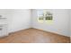 Bright bedroom with wood-look tile flooring and a large window at 2569 Rogers Rd, Lakeland, FL 33812