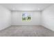 Bright, carpeted bedroom with natural light streaming through the window, creating a relaxing ambiance at 2569 Rogers Rd, Lakeland, FL 33812