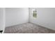 Cozy bedroom featuring plush carpeting and a window that offers plenty of natural light at 2569 Rogers Rd, Lakeland, FL 33812