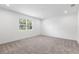 Cozy bedroom featuring carpet flooring and a window with natural light at 2569 Rogers Rd, Lakeland, FL 33812