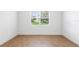 Bright bedroom with wood-look tile flooring and a large window at 2569 Rogers Rd, Lakeland, FL 33812