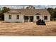 Beautiful single-story home featuring light exterior and landscaping, complete with a tractor in the spacious yard at 2569 Rogers Rd, Lakeland, FL 33812