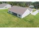 Aerial view showcasing the home's backyard with ample green space and covered patio at 2569 Rogers Rd, Lakeland, FL 33812