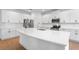 Gourmet kitchen boasts a large island with quartz countertops and stainless appliances at 2569 Rogers Rd, Lakeland, FL 33812