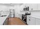 Contemporary kitchen with white countertops, stainless steel appliances, and ample cabinetry at 2569 Rogers Rd, Lakeland, FL 33812