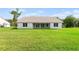 Back of home featuring a large yard and covered patio at 2569 Rogers Rd, Lakeland, FL 33812