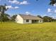Back view of the home with a large yard, perfect for outdoor activities and relaxation at 2569 Rogers Rd, Lakeland, FL 33812
