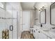Bathroom featuring double sinks with white marble countertops and a glass enclosed shower at 5618 Winterbrook Way, Winter Park, FL 32792