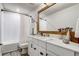 Well-lit bathroom featuring a shower-tub combo, a large vanity with storage, and a wood-framed mirror at 5618 Winterbrook Way, Winter Park, FL 32792