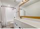 Bathroom featuring white cabinets, a large mirror, bronze fixtures, and a tub/shower combo at 5618 Winterbrook Way, Winter Park, FL 32792