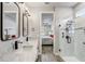 Bathroom featuring double sinks with white marble countertops and a glass enclosed shower at 5618 Winterbrook Way, Winter Park, FL 32792
