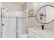 Bright bathroom featuring a glass-enclosed shower, modern vanity with a round mirror, and stylish fixtures at 5618 Winterbrook Way, Winter Park, FL 32792
