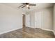 Bedroom with hardwood floors and ceiling fan, with entry to an ensuite bathroom at 5618 Winterbrook Way, Winter Park, FL 32792
