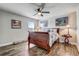 Cozy bedroom with a sleigh bed, wood floors, ceiling fan, and decorative artwork on the walls at 5618 Winterbrook Way, Winter Park, FL 32792