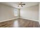 Bedroom with hardwood floors and ceiling fan, featuring natural light from one window at 5618 Winterbrook Way, Winter Park, FL 32792