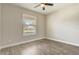 Clean, empty bedroom with wood-look floors and natural light from the window at 5618 Winterbrook Way, Winter Park, FL 32792