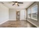 Bright bedroom with ceiling fan, wood-look floors, and view to ensuite bathroom at 5618 Winterbrook Way, Winter Park, FL 32792