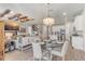 Bright dining area with decorative chandelier, glass table, and an open view of the kitchen at 5618 Winterbrook Way, Winter Park, FL 32792